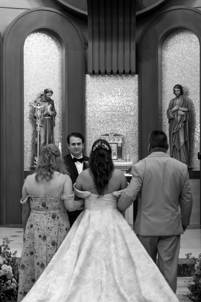 Bride walking down aisle with parents during church ceremony St Augustine Florida destination wedding