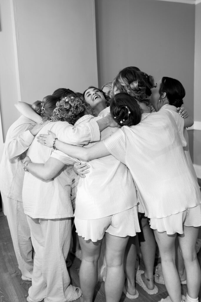 Bridesmaids group hug getting ready wedding morning St Augustine Florida destination wedding