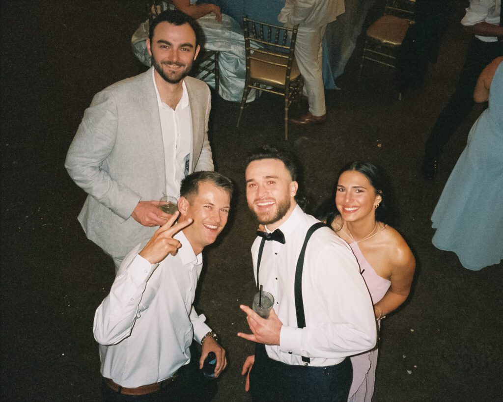 Wedding guests smiling and posing on dance floor at Lightner Museum reception St Augustine Florida