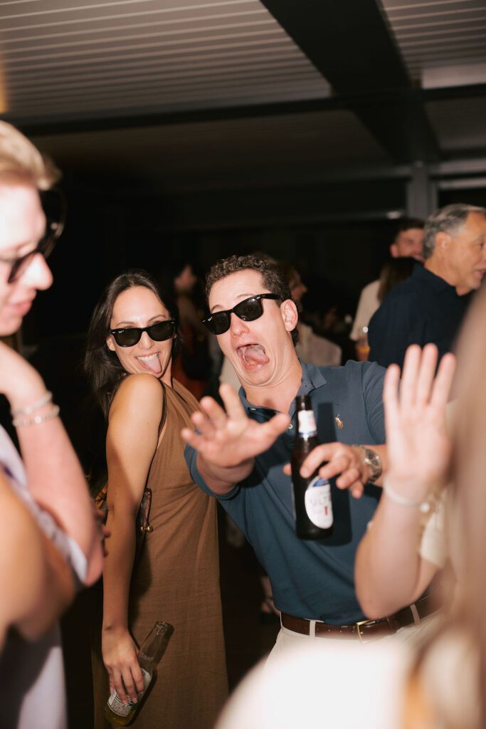 St Augustine Florida wedding rehearsal dinner guests laughing and socializing at rooftop bar destination wedding weekend