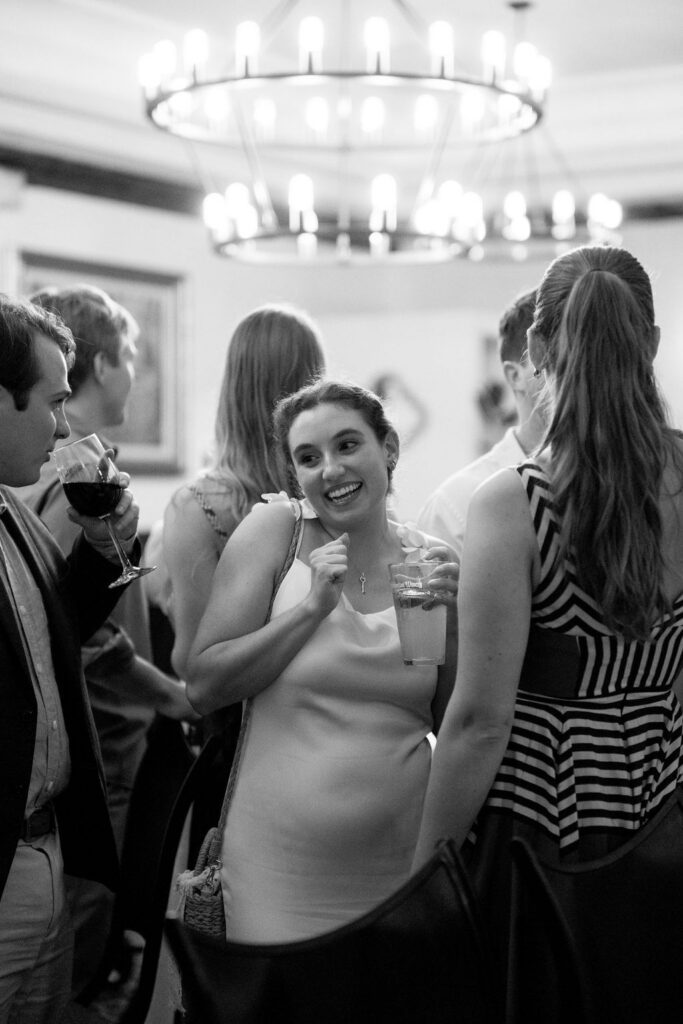 St Augustine Florida wedding rehearsal dinner guests laughing and socializing at rooftop bar destination wedding weekend