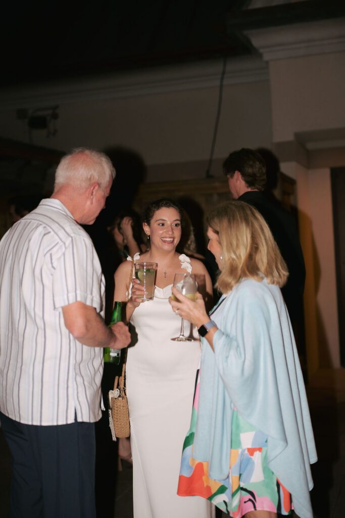 St Augustine Florida wedding rehearsal dinner guests laughing and socializing at rooftop bar destination wedding weekend
