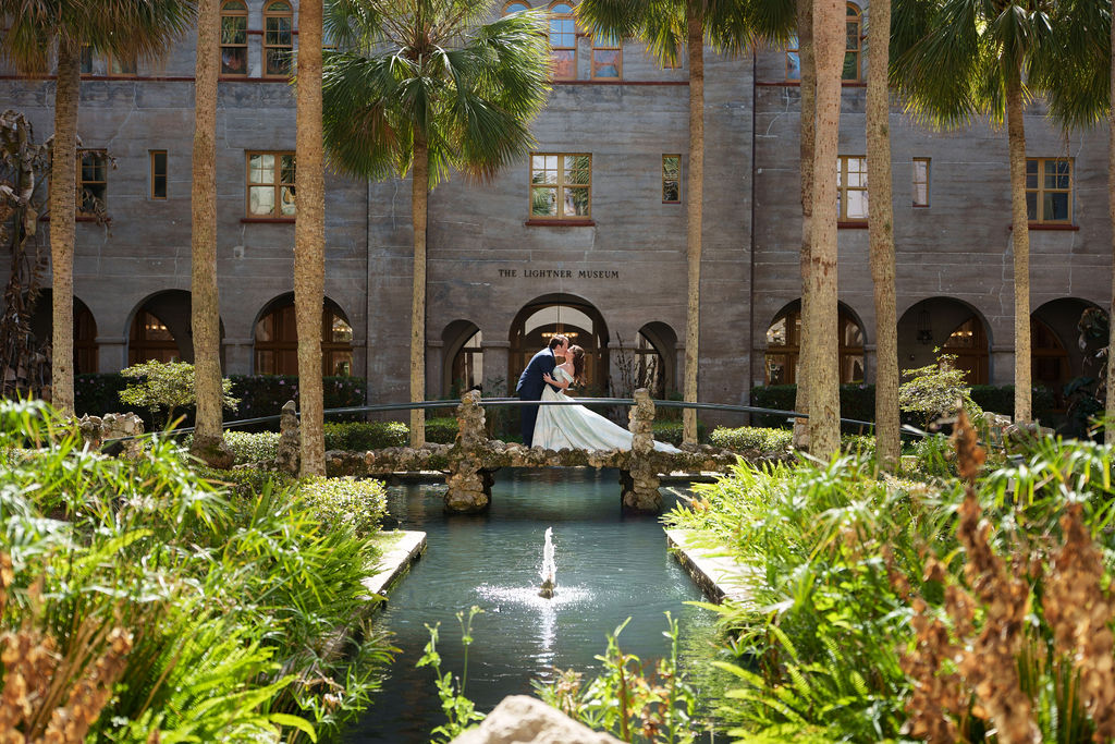 Lightner Museum wedding St Augustine Florida bride and groom kissing on bridge destination wedding photographer