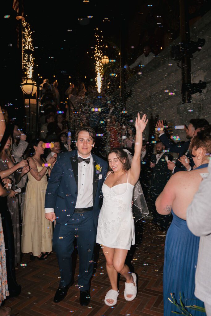 Bride and groom bubble exit with guests and sparklers at St Augustine Florida destination wedding reception