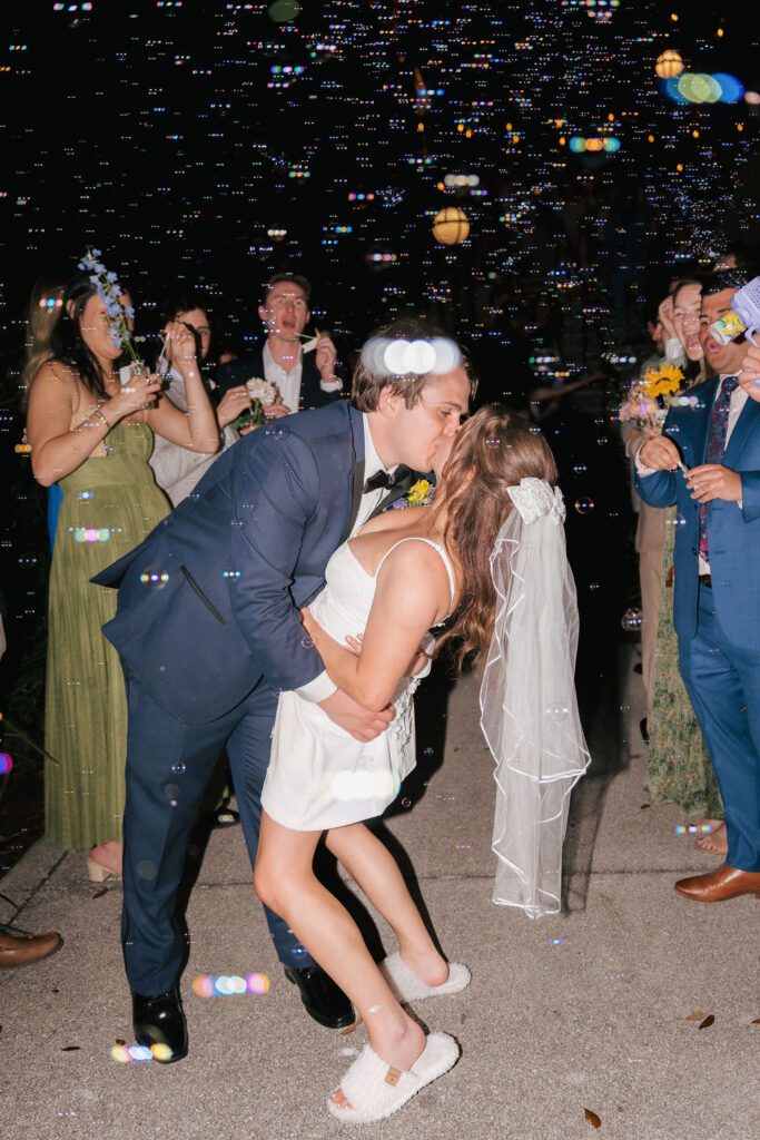 Bride and groom kissing during bubble exit send off St Augustine Florida wedding night celebration
