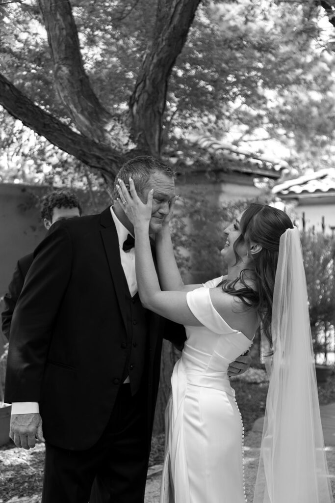 Bride holding her father's face as he cries during their first look at Villa Parker