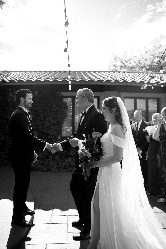 Father of the bride shaking the groom's hand as he gives her away at Villa Parker