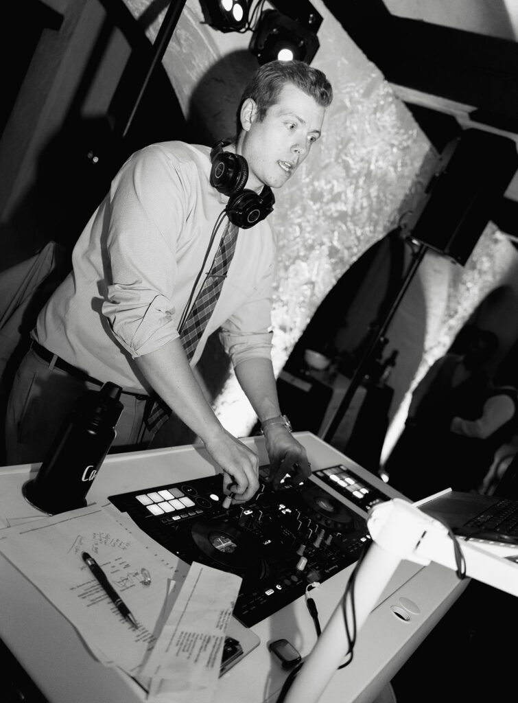 DJ mixing behind the booth during a Villa Parker wedding reception