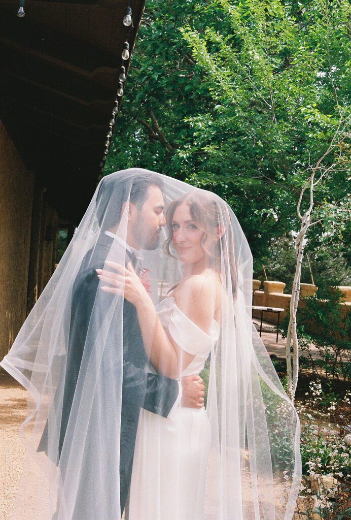 35mm film photo of bride and groom under veil at Villa Parker
